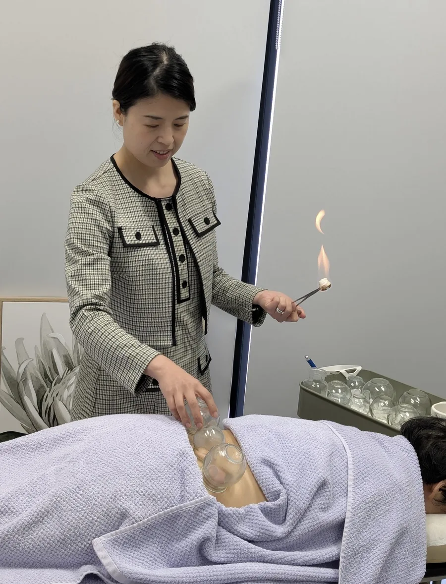 A practitioner applying fire cupping during treatment